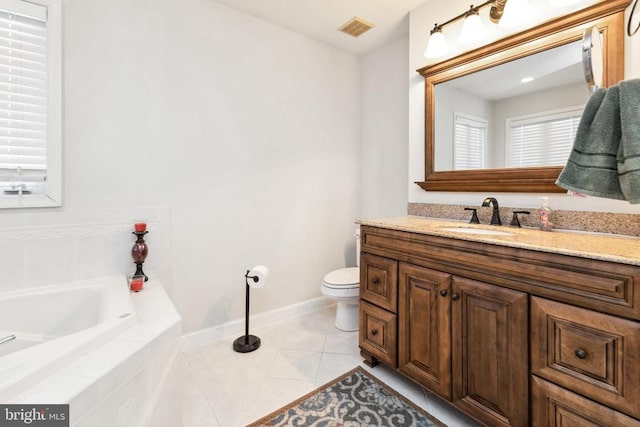 bathroom with tile patterned floors, toilet, tiled bath, and vanity