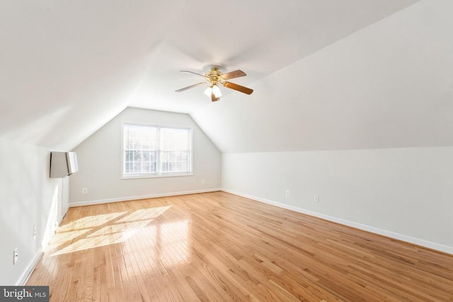 bonus room featuring lofted ceiling, light hardwood / wood-style floors, and ceiling fan