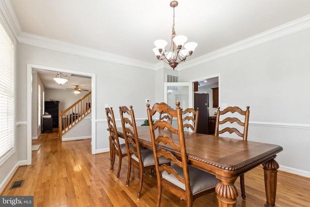 dining area with ornamental molding, light hardwood / wood-style floors, and a wealth of natural light