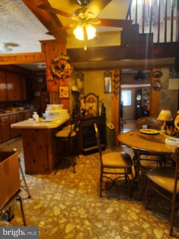 dining space with ceiling fan and a textured ceiling