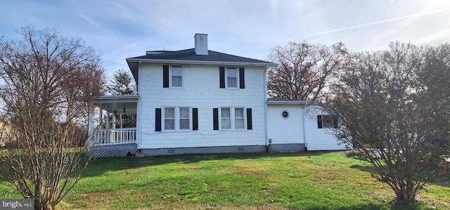 back of house featuring a yard