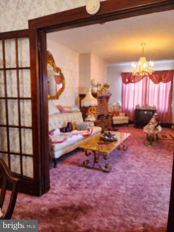 carpeted living room featuring a notable chandelier