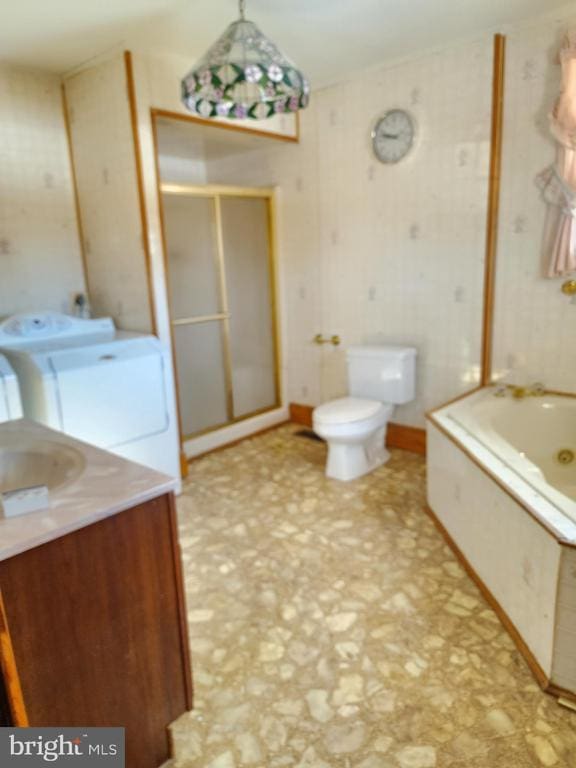 full bathroom with washer and clothes dryer, vanity, toilet, and independent shower and bath