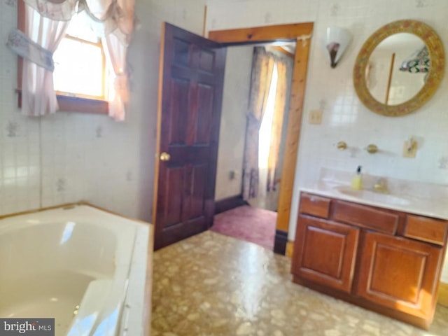 bathroom featuring vanity and a tub to relax in