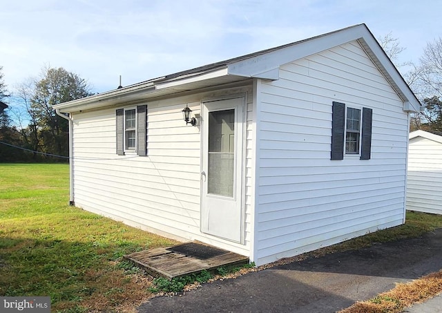 view of property exterior featuring a lawn