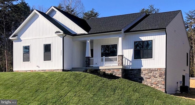 modern farmhouse with central AC, covered porch, and a front lawn