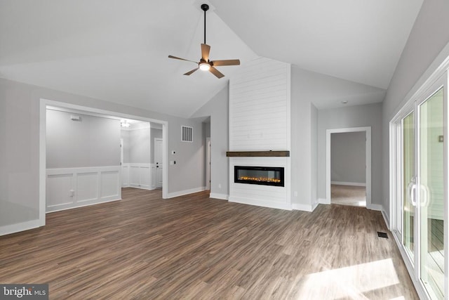 unfurnished living room featuring ceiling fan, a fireplace, and dark wood-type flooring