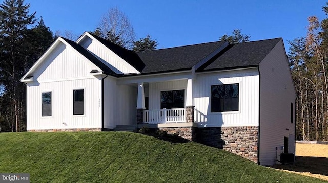 modern farmhouse featuring a front lawn and a porch