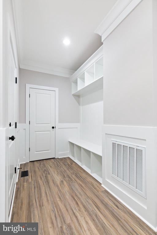 mudroom with hardwood / wood-style flooring and crown molding