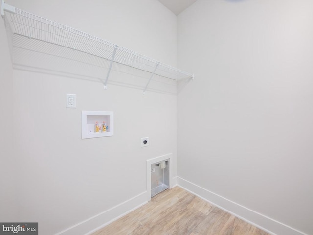 clothes washing area featuring hookup for an electric dryer, hookup for a washing machine, and light hardwood / wood-style flooring