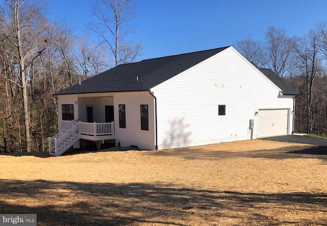 rear view of house featuring a garage