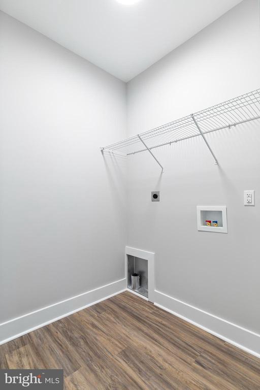 laundry room featuring electric dryer hookup, hookup for a washing machine, and dark hardwood / wood-style floors