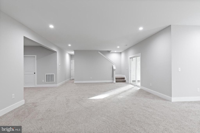 basement featuring light colored carpet