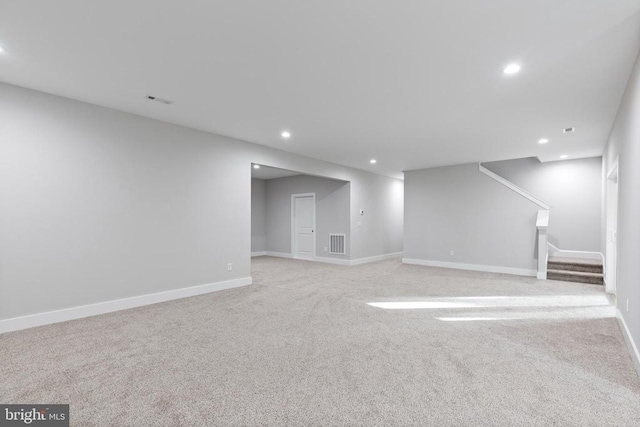 basement featuring light carpet