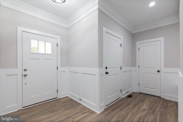 foyer entrance with dark hardwood / wood-style floors and crown molding