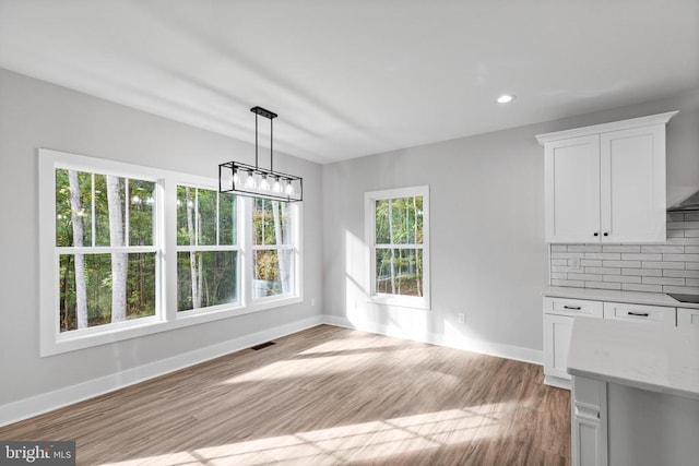 unfurnished dining area with plenty of natural light and light hardwood / wood-style floors