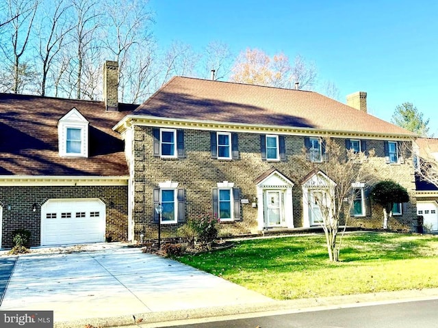 view of front of house featuring a garage and a front lawn