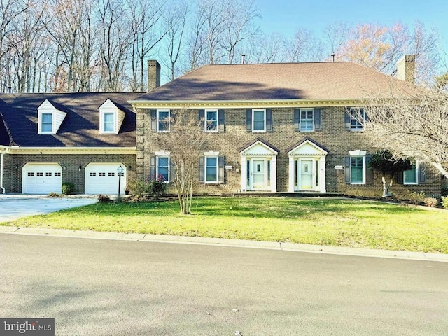 view of front of house with a front yard and a garage