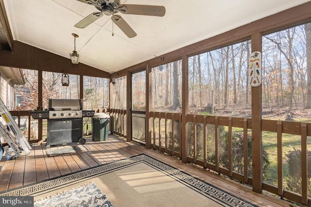 sunroom featuring ceiling fan and vaulted ceiling