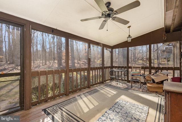 unfurnished sunroom with ceiling fan and lofted ceiling