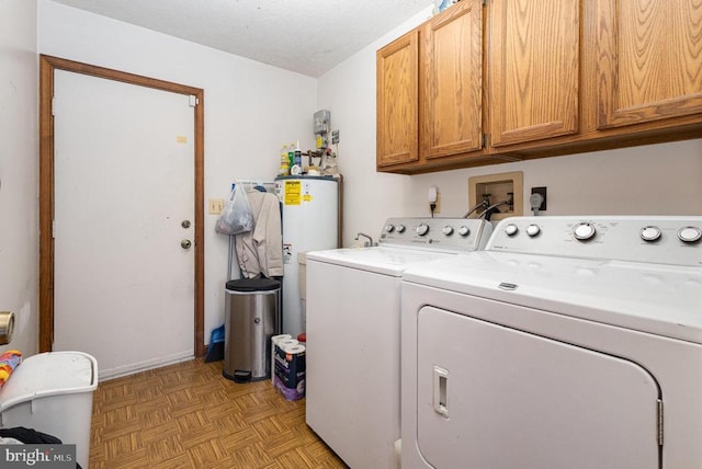 washroom featuring light parquet floors, cabinets, gas water heater, and independent washer and dryer