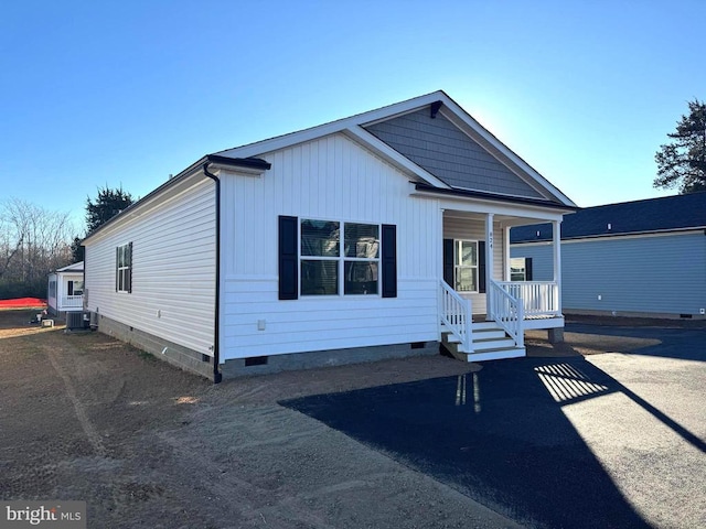 view of front facade featuring central air condition unit and covered porch