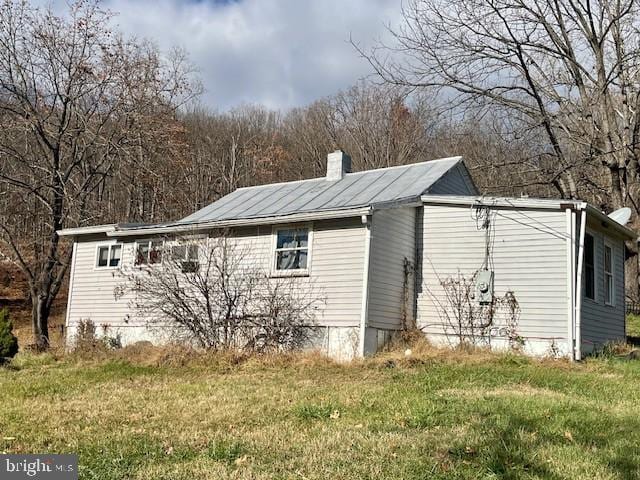 view of home's exterior with a lawn