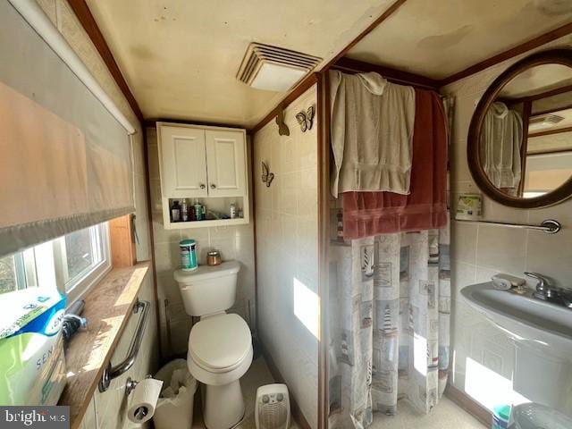 bathroom featuring walk in shower, tasteful backsplash, toilet, and tile walls