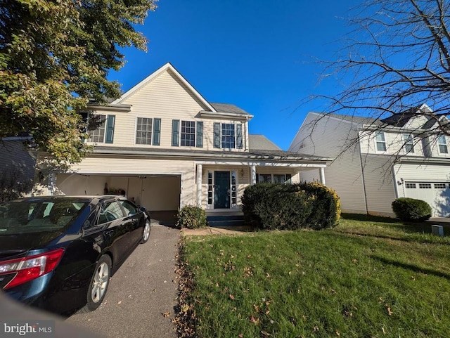 view of front property featuring a front lawn and a garage