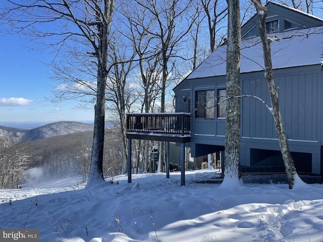 exterior space with a deck with mountain view