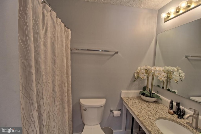 bathroom featuring sink, a textured ceiling, and toilet