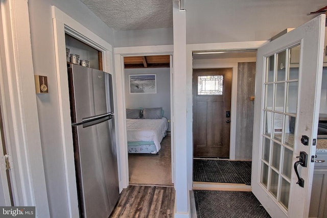 interior space featuring dark hardwood / wood-style floors and a textured ceiling