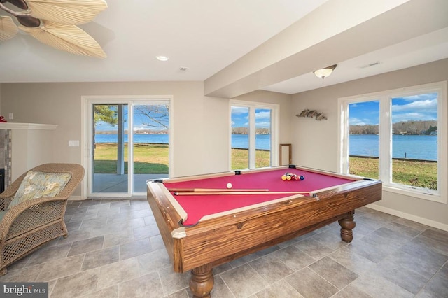 recreation room featuring plenty of natural light and a water view