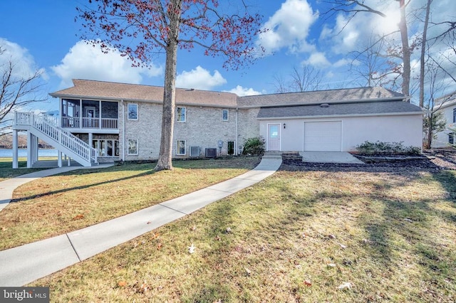 view of front of house featuring a sunroom and a front yard