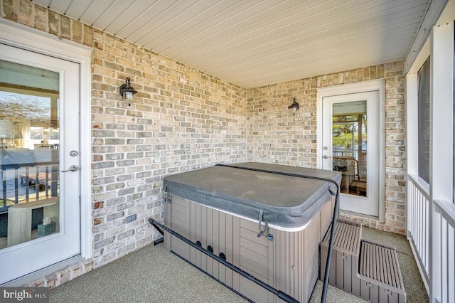 view of patio / terrace with a hot tub