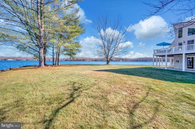 view of yard with a water view and a patio area