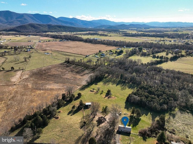 birds eye view of property featuring a mountain view and a rural view