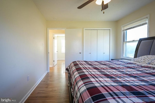 bedroom with hardwood / wood-style floors, a closet, and ceiling fan