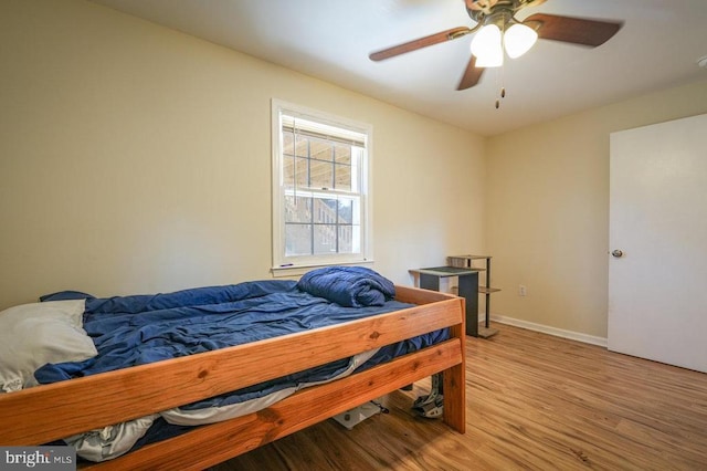 bedroom with ceiling fan and light hardwood / wood-style floors