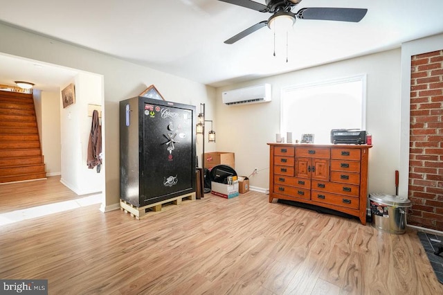 miscellaneous room with light hardwood / wood-style floors and a wall unit AC