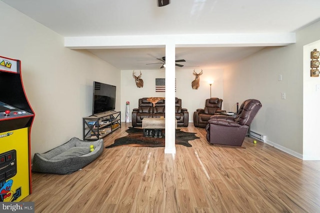 living room with hardwood / wood-style flooring, ceiling fan, and a baseboard radiator