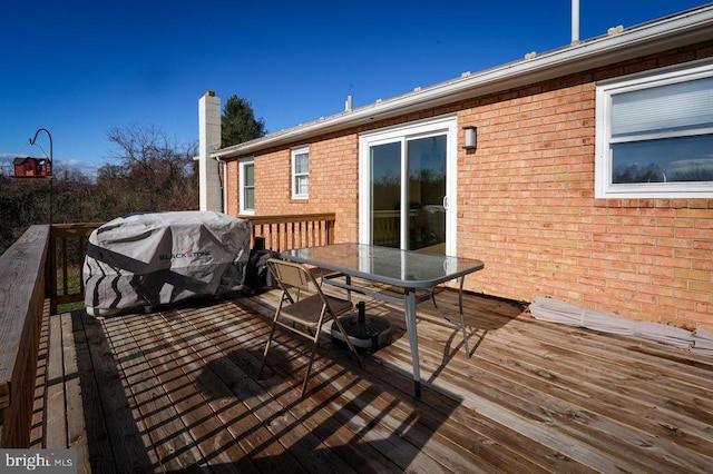 wooden deck featuring area for grilling