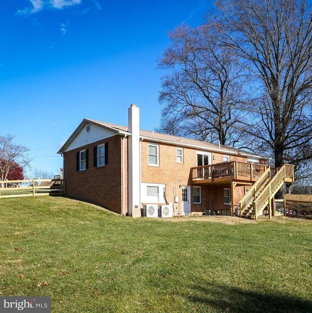 back of house with ac unit, a lawn, and a wooden deck