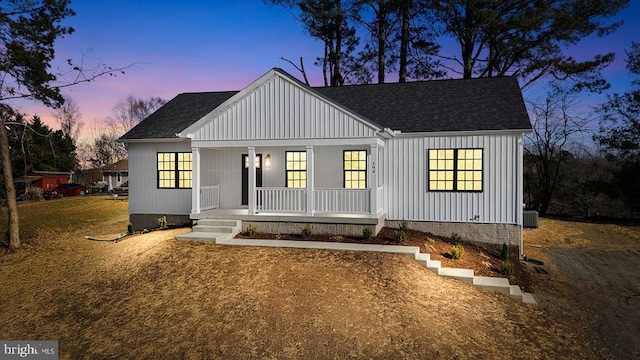 view of front of house with a porch and central AC