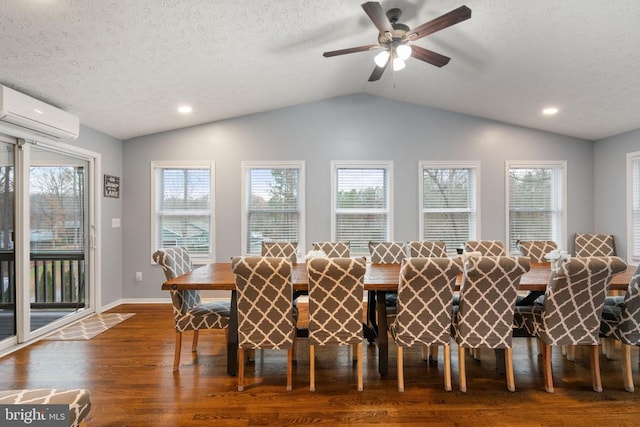 dining space featuring dark hardwood / wood-style floors, a healthy amount of sunlight, and an AC wall unit