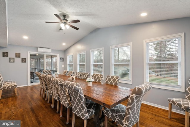 dining area featuring plenty of natural light, ceiling fan, dark wood-type flooring, and a wall mounted AC