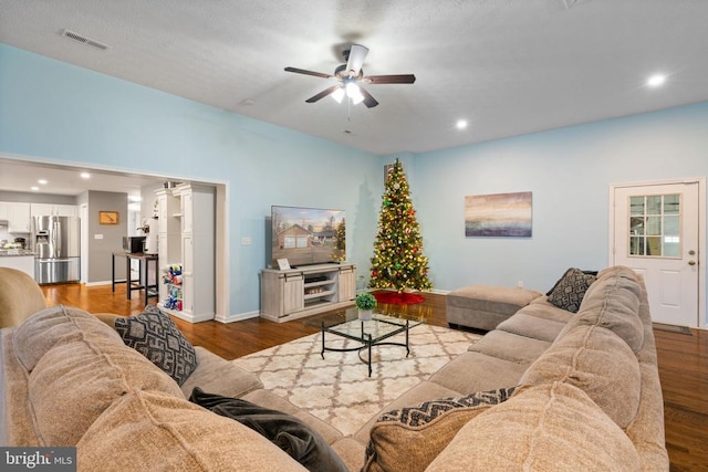 living room featuring ceiling fan and light hardwood / wood-style floors