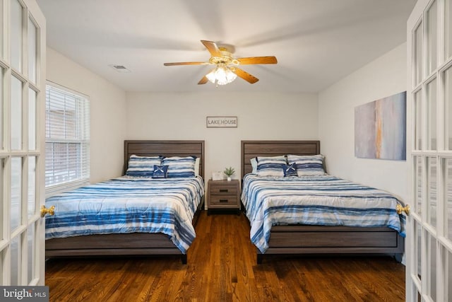 bedroom with ceiling fan, dark wood-type flooring, and french doors