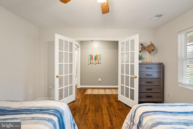 bedroom with ceiling fan, dark hardwood / wood-style flooring, french doors, and multiple windows