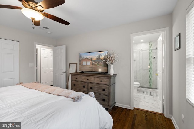 bedroom featuring ceiling fan, dark hardwood / wood-style flooring, and ensuite bath